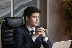 portrait of a businessman in a dark blue suit in the office Product Image 1