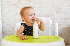 baby girl with milk sitting in chair in sunny kitchen Product Image 1