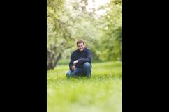 Middle-aged man resting in the city park Product Image 1
