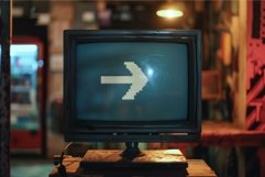 Old analog television set displaying pixel arrow right direc Product Image 1