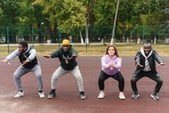 Diverse people doing sit-ups outdoors Product Image 1