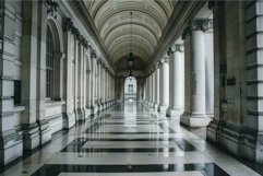 Empty corridor with columns leading to entrance of historic Product Image 1
