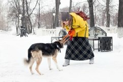 Beautiful smiling young woman is playing with her dog. Product Image 1