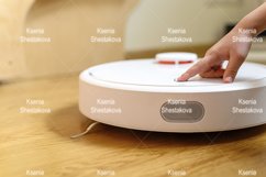 kids hand press button to turn the robot vacuum cleaner on Product Image 1