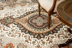 Antique chair and table on the decorated oriental carpet Product Image 1