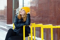 Young woman on the snowy street of city. Product Image 1