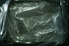 Crumpled aluminum foil is covering a baking tray Product Image 1