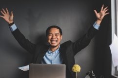 Excited happy and smiling businessman showing winner gesture Product Image 1