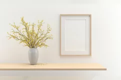 A closeup shot of a plant in a vase next to a frame Product Image 2