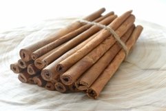 Bundle of cinnamon sticks on wooden surface Product Image 1