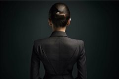 Rear view of a businesswoman in a professional black suit on Product Image 1