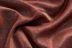 red fabric with a glittery texture and smooth folds Product Image 1