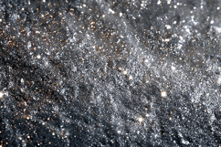 A dark surface covered with white specks and particles Product Image 1