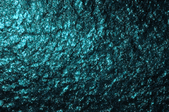 A dark textured surface with a turquoise glitter effects Product Image 1