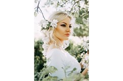 Beautiful young blonde girl in blooming Apple orchard. Product Image 1