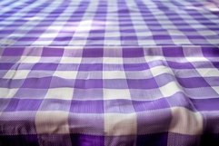 Purple gingham tablecloth forming wavy surface Product Image 1