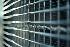 Close up of metallic chrome grille reflecting light Product Image 1