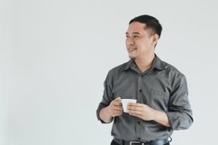 Businessman looking empty space while holding a coffee cup Product Image 1