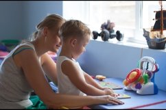 Mother playing learning game with son Product Image 1