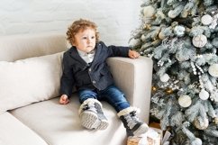 Little 2 year old boy sitting on the sofa Product Image 1