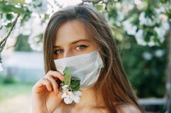 Girl in a face mask in a blooming Apple orchard. Product Image 1