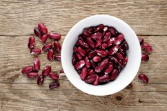 Beans in bowl on wooden table top view Product Image 1