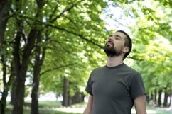 Young caucasian man enjoy nature in the sunny forest Product Image 1