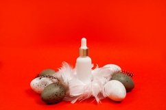 Cosmetic essential oil or serum in the nest with easter eggs Product Image 1