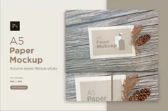 A5 paper mockup with dry leaves on wooden background Product Image 1