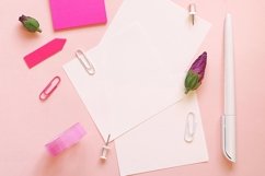 Stationery and hibiscus buds on a pink background Product Image 1
