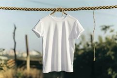 Blank white t-shirt hanging on outdoor clothesline Product Image 1