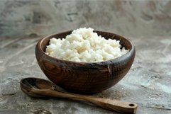 Steaming bowl of white rice sitting on rustic kitchen table Product Image 1
