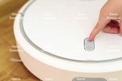 kids hand press button to turn the robot vacuum cleaner on Product Image 1