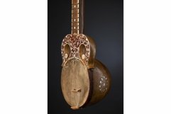 Part ancient Asian stringed musical instrument on black Product Image 1