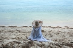 Woman looking at sea view on the beach Product Image 1
