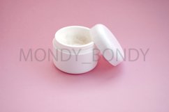 White bottle of cream on a pink background. Flat lay. Product Image 1