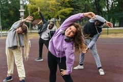 Caucasian woman looking at camera and stretching with friend Product Image 1