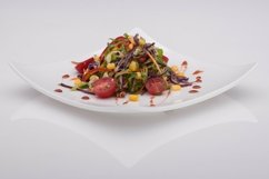 Salad in a white plate on a white background Product Image 1