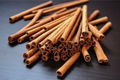 Aromatic cinnamon sticks on dark surface Product Image 1