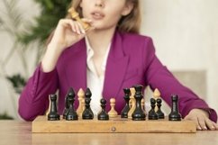 young girl with long blond hair plays chess Product Image 1