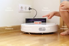 kids hand press button to turn the robot vacuum cleaner on Product Image 1