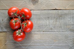 Tomatoes on wooden table top view Product Image 1