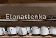 glazed ceramic dishes stand on a shelf in the workshop Product Image 1