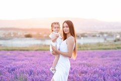 Beautiful woman holding little baby girl in lavender field Product Image 1