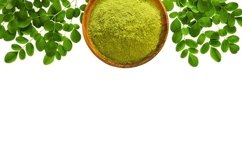 Moringa powder with original fresh leaves isolated on white Product Image 1