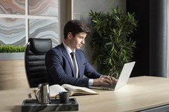 portrait of a businessman in a dark blue suit in the office Product Image 1