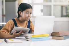 Primary school girl learning online at home. Product Image 1