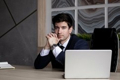 portrait of a businessman in a dark blue suit in the office Product Image 1