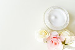 cosmetic cream with herbal flowers on white table Product Image 1