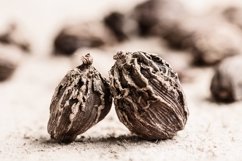 Whole black cardamom on wooden rustic background close-up. Product Image 1